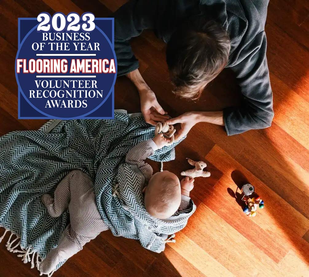 Mother and baby playing on a hardwood floor