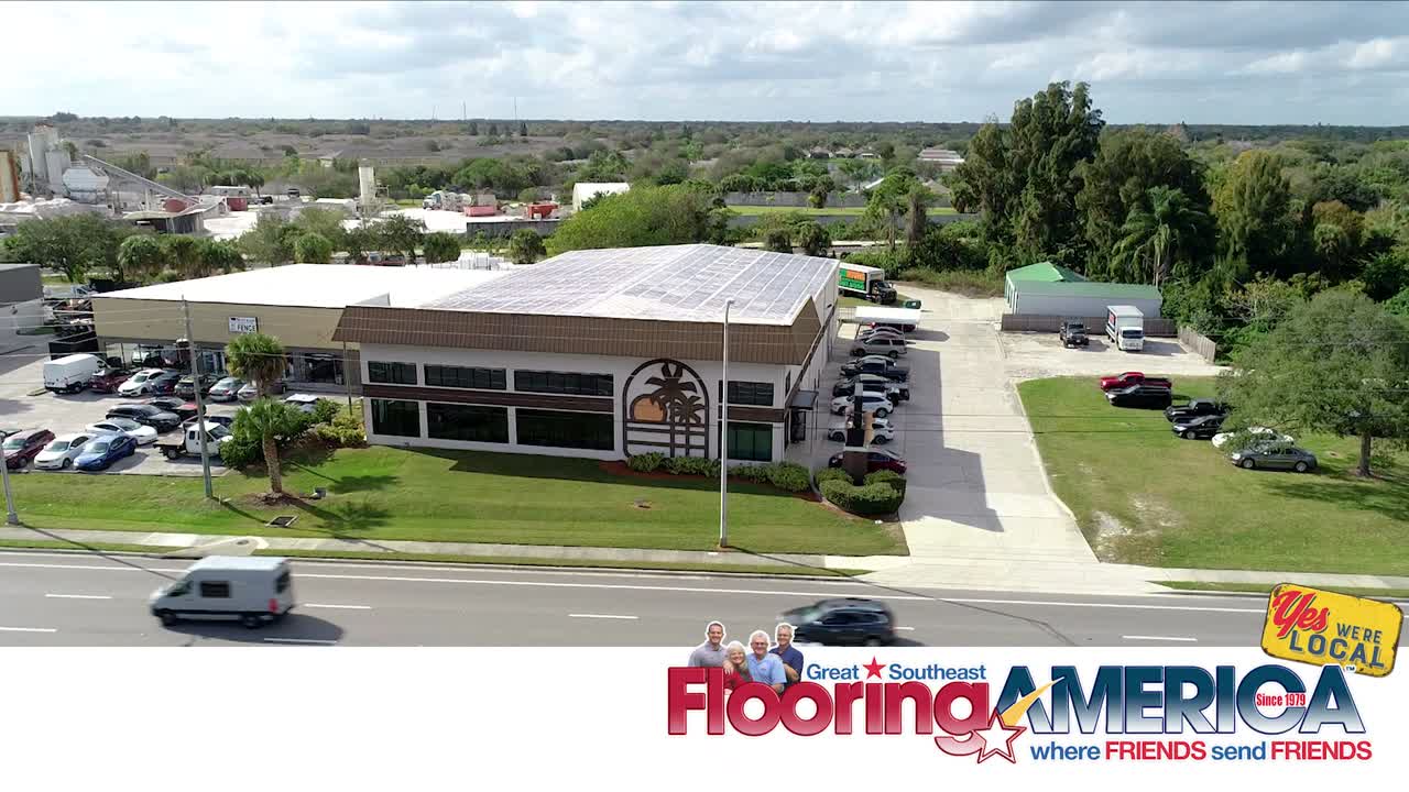 Southeast Flooring America showroom exterior with a palm tree and sun graphic on the side.
